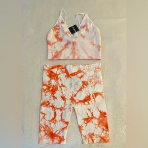 NWT. Charlotte Russe 2-piece biker shorts with matching bralette. Size L.